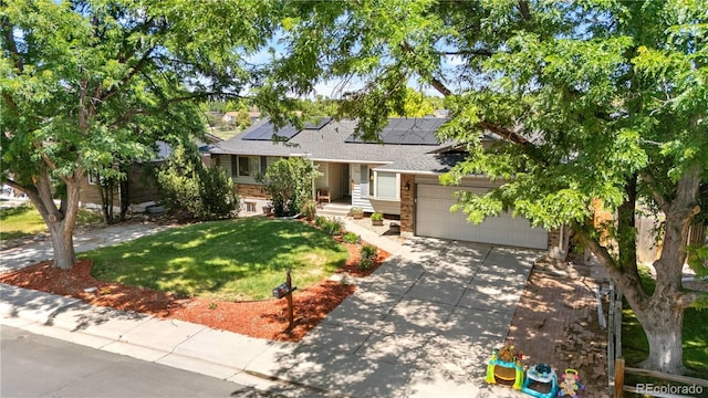 17503 E Lasalle Dr, Aurora, CO 80013 - view of front of house featuring concrete driveway, a front yard, solar panels, a garage, and a shingled roof