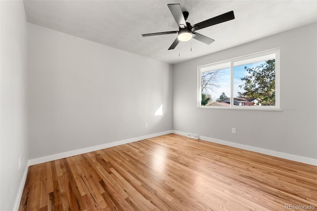 spare room with light hardwood / wood-style flooring and ceiling fan