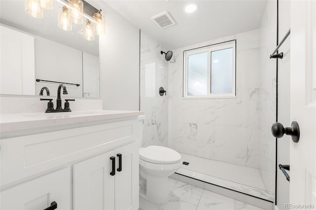 bathroom featuring vanity, toilet, and a tile shower