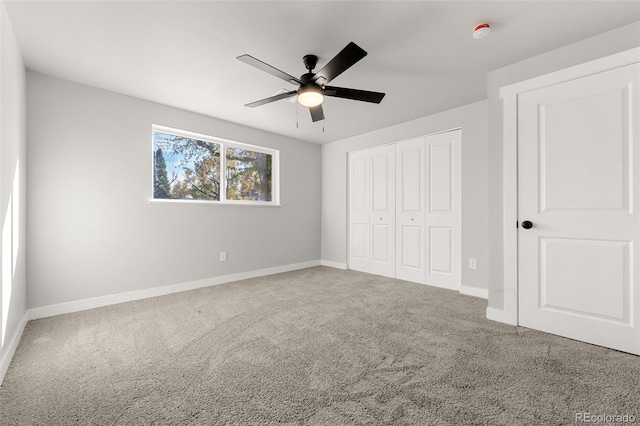 unfurnished bedroom with a closet, ceiling fan, and carpet floors