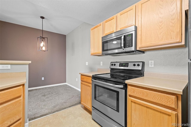 kitchen featuring light carpet, baseboards, appliances with stainless steel finishes, light countertops, and light brown cabinets