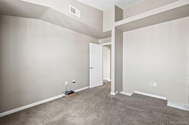 carpeted spare room with vaulted ceiling, visible vents, and baseboards