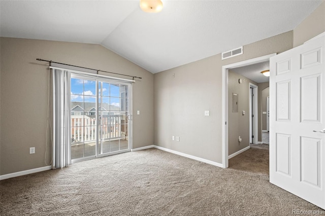 empty room featuring carpet floors, baseboards, visible vents, and lofted ceiling