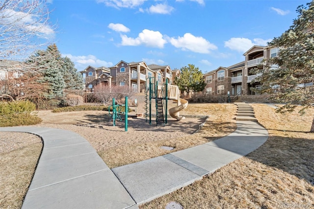 communal playground featuring a residential view