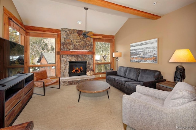 living room featuring vaulted ceiling with beams, a wealth of natural light, a fireplace, and ceiling fan