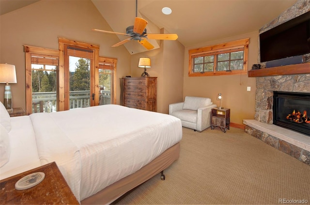 bedroom with a stone fireplace, access to outside, light colored carpet, and vaulted ceiling