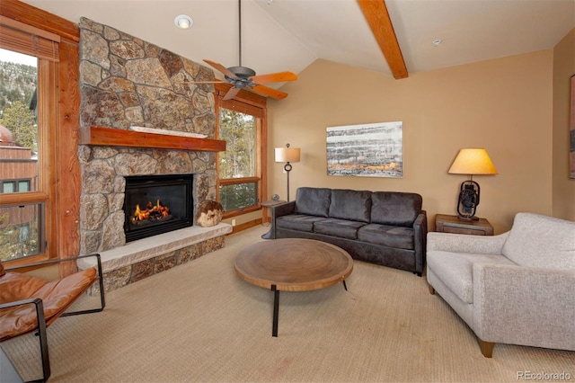 carpeted living room featuring vaulted ceiling with beams, a wealth of natural light, and a fireplace