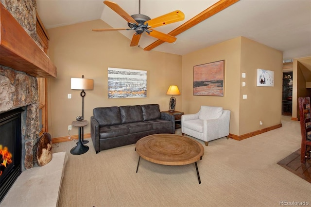 living room with carpet, baseboards, vaulted ceiling, and a stone fireplace