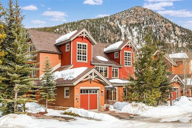 view of front of house with a garage and a mountain view