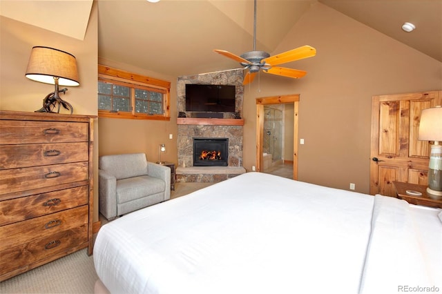 carpeted bedroom with high vaulted ceiling and a stone fireplace