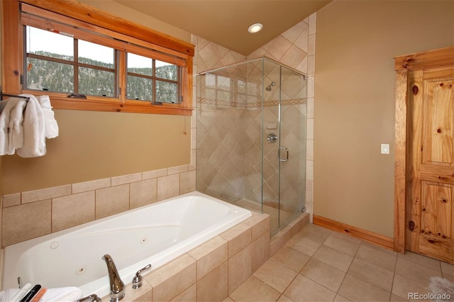 bathroom with a stall shower, baseboards, a whirlpool tub, and tile patterned floors