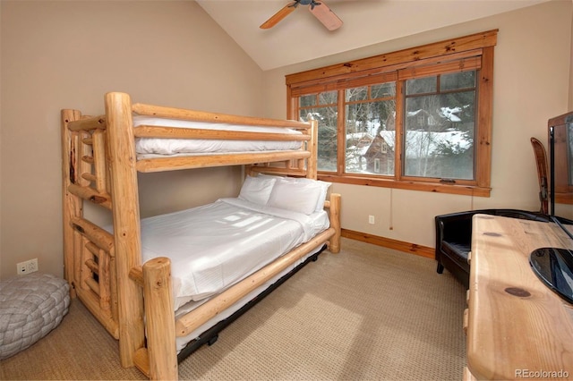 carpeted bedroom with vaulted ceiling, a ceiling fan, and baseboards