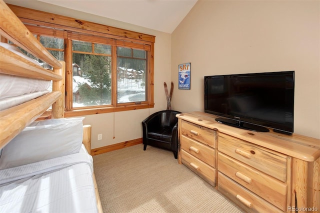 bedroom with lofted ceiling, baseboards, and light colored carpet