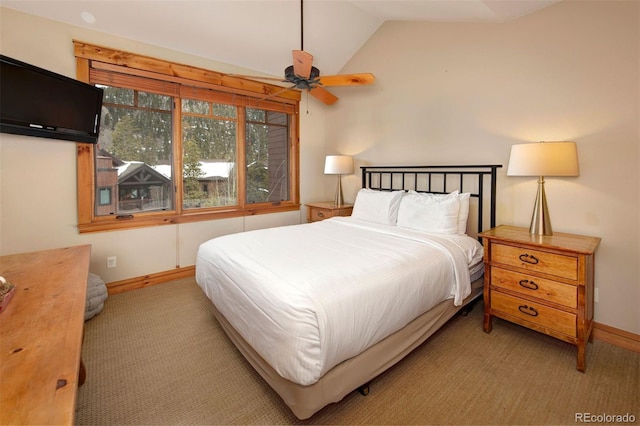 carpeted bedroom with vaulted ceiling and baseboards