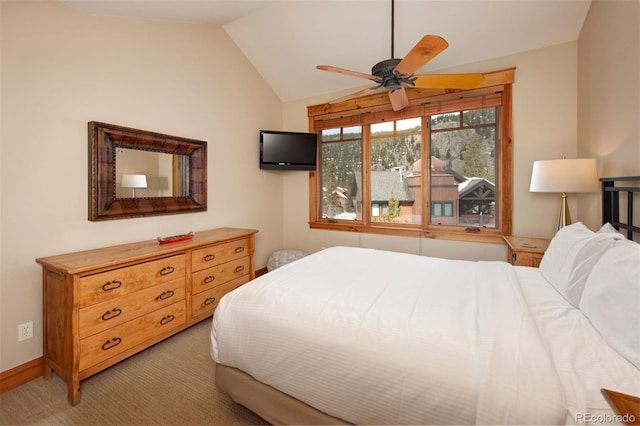 bedroom with light carpet, vaulted ceiling, and baseboards