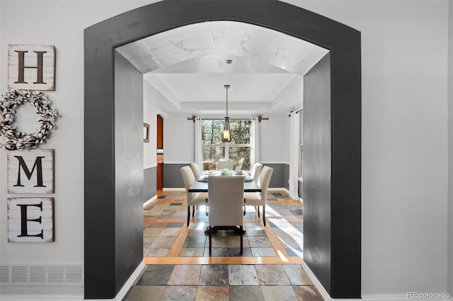 dining area featuring a raised ceiling