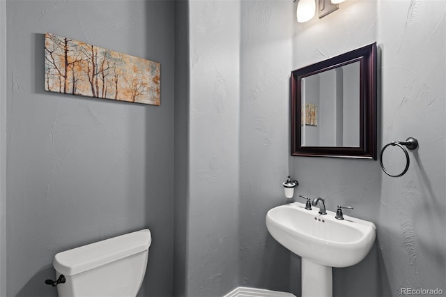 bathroom with toilet and sink