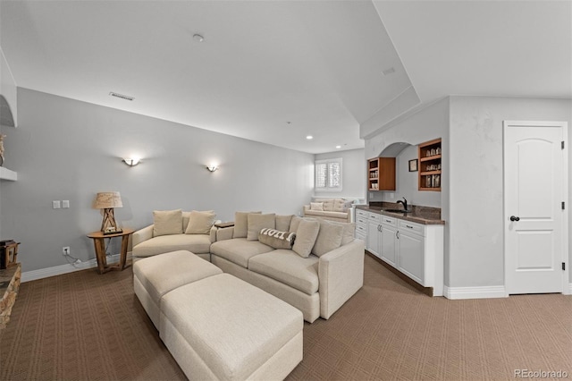 living room featuring sink and carpet