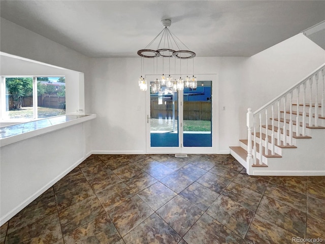4416 S Vivian St, Morrison, CO 80465 - unfurnished dining area featuring a chandelier and stairway