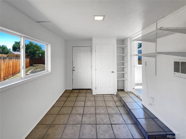 4416 S Vivian St, Morrison, CO 80465 - tiled empty room with built in shelves and baseboards