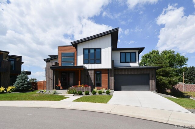 4224 E Dickenson Pl, Denver, CO 80222 - contemporary house featuring driveway, brick siding, and an attached garage