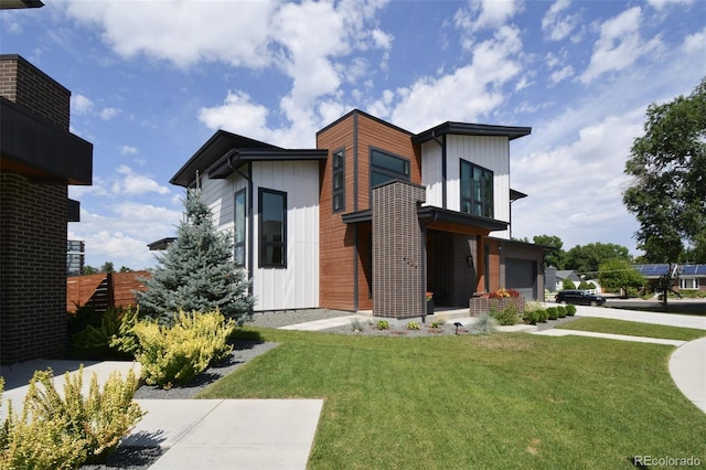 view of front of house with a front yard and a garage