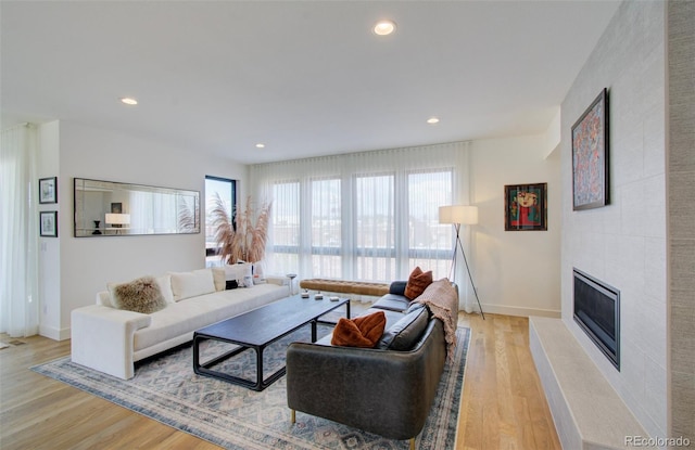4224 E Dickenson Pl, Denver, CO 80222 - living room with light wood-style flooring, recessed lighting, and a fireplace