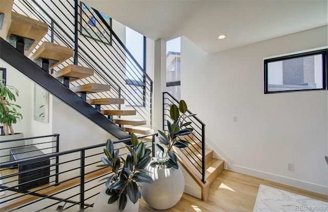 stairway with hardwood / wood-style flooring