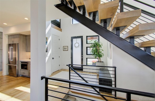 stairway with hardwood / wood-style flooring