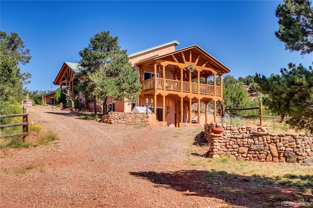 back of house with a balcony