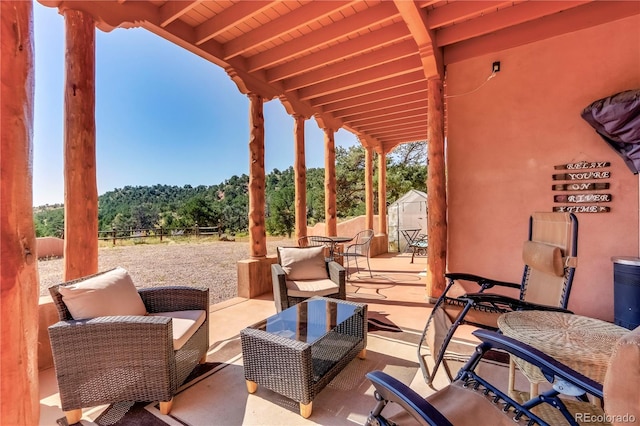 view of patio with outdoor dining area, an outbuilding, a storage shed, and fence