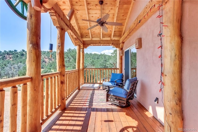 wooden terrace featuring a ceiling fan