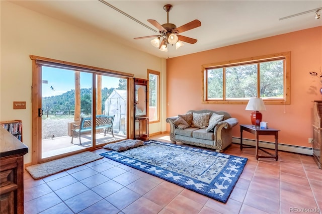 living room with ceiling fan, a baseboard heating unit, and light tile patterned flooring