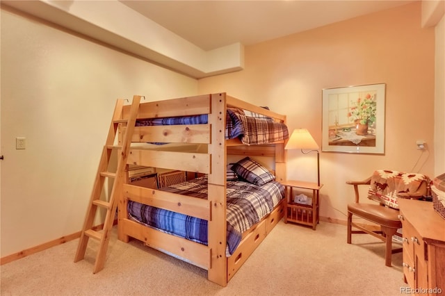 bedroom with baseboards and carpet