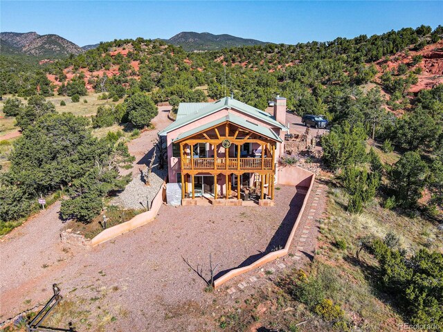 back of house featuring a patio and a deck with mountain view