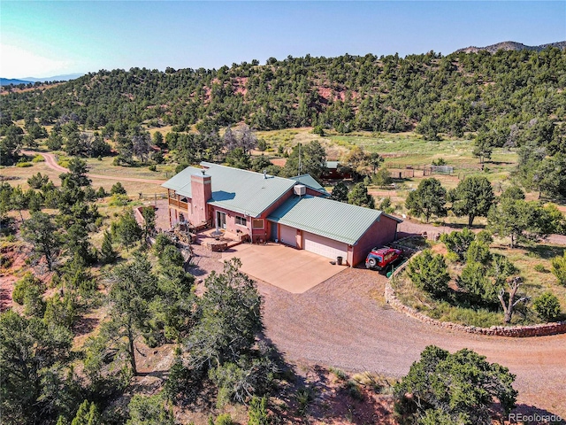 birds eye view of property with a view of trees