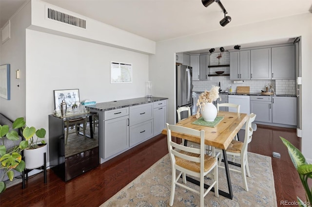790 N Washington St Unit 1210, Denver, CO 80203 - kitchen with freestanding refrigerator, open shelves, dark wood finished floors, decorative backsplash, and gray cabinetry
