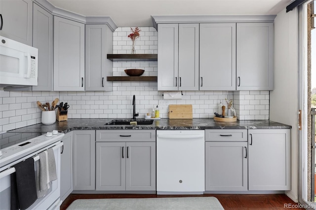 790 N Washington St Unit 1210, Denver, CO 80203 - kitchen featuring white appliances, open shelves, gray cabinets, backsplash, and dark stone counters