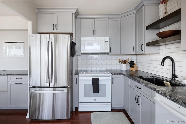 790 N Washington St Unit 1210, Denver, CO 80203 - kitchen featuring white appliances, open shelves, backsplash, gray cabinets, and dark stone countertops