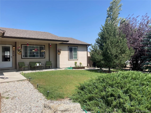 view of front of property with a front lawn and a patio