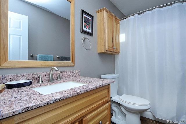 bathroom featuring vanity, tile patterned floors, and toilet