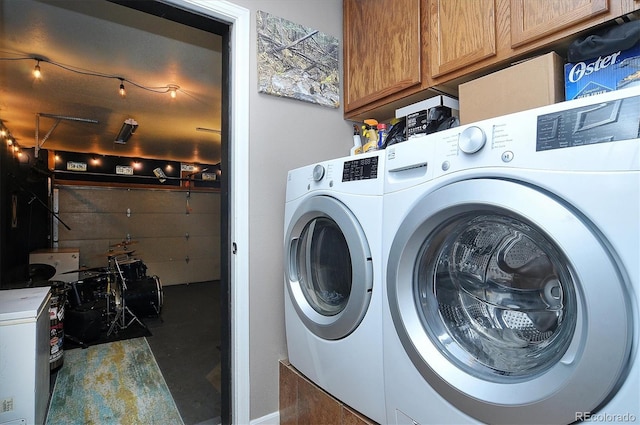 laundry area with cabinets and washing machine and dryer