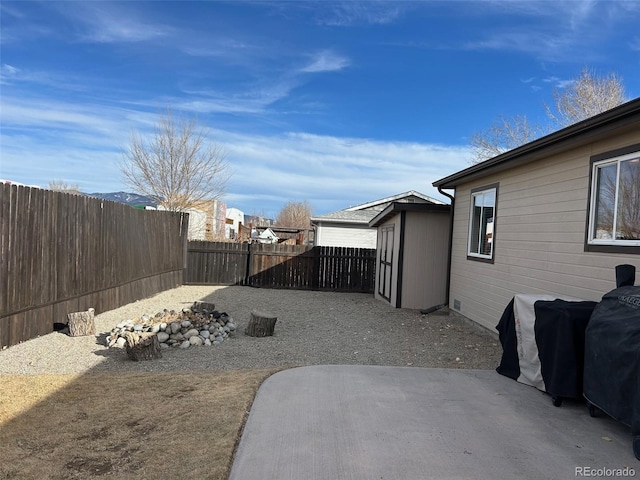 view of yard with a shed and a patio area