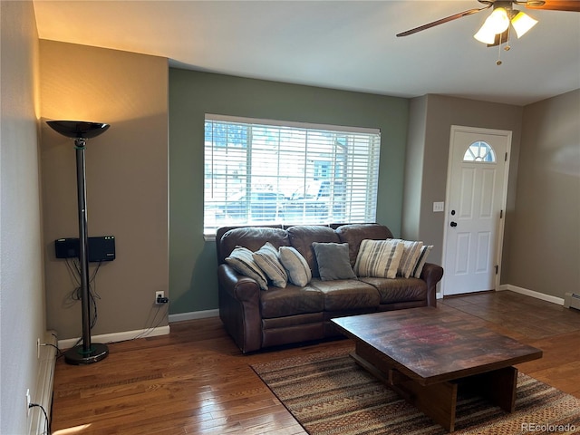 living room featuring wood-type flooring and ceiling fan