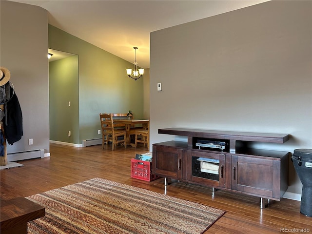 living room featuring hardwood / wood-style flooring, lofted ceiling, a baseboard heating unit, and a chandelier