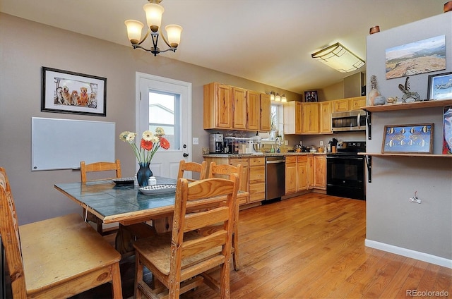 kitchen with vaulted ceiling, appliances with stainless steel finishes, a notable chandelier, light hardwood / wood-style floors, and light brown cabinets