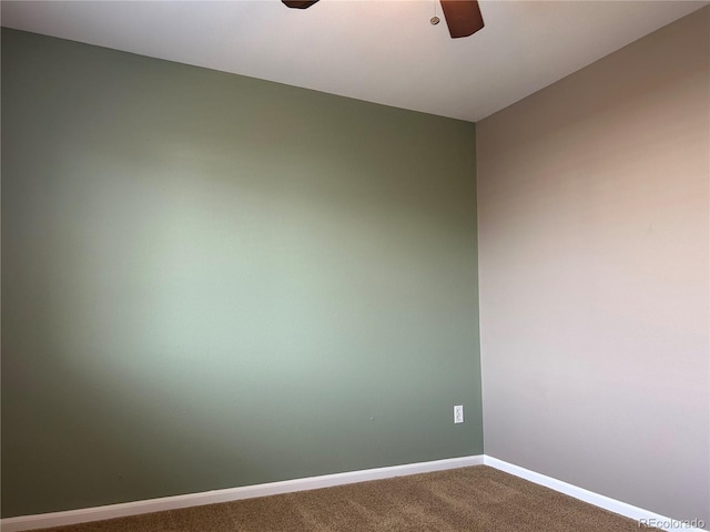 spare room featuring carpet flooring and ceiling fan