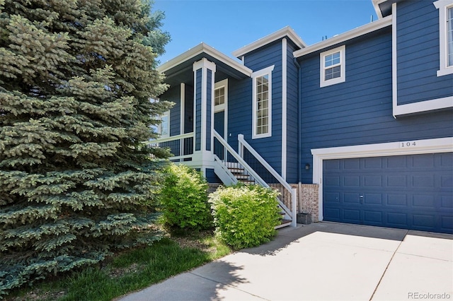 104 Willowick Cir, Highlands Ranch, CO 80129 - view of front of property with stairs, an attached garage, concrete driveway, and brick siding