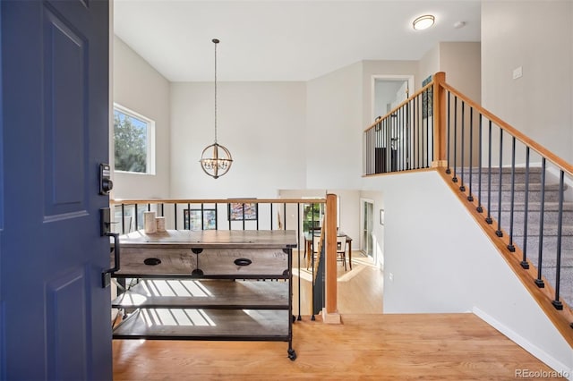104 Willowick Cir, Highlands Ranch, CO 80129 - foyer entrance with a chandelier, wood finished floors, and a high ceiling