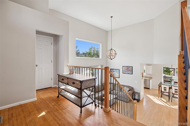 104 Willowick Cir, Highlands Ranch, CO 80129 - stairs with a towering ceiling, hardwood / wood-style floors, and a chandelier